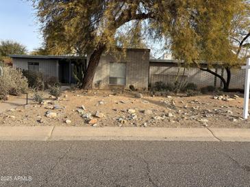 Ranch style home with brick exterior and a landscaped front yard at 6240 E Larkspur Dr, Scottsdale, AZ 85254