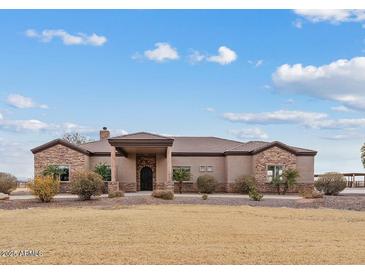 Single-story home with stone accents and a large front yard at 11293 N Thunder Mountain Rd, Coolidge, AZ 85128