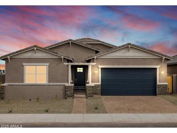 Beautiful single-story home featuring a two-car garage and well-manicured landscaping at 4828 N 177Th Ln, Goodyear, AZ 85395
