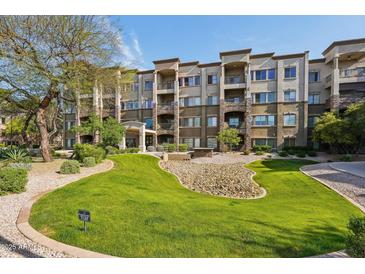 Beautiful condo building showcasing well-maintained landscaping and inviting entrance on a sunny day at 5450 E Deer Valley Dr # 4015, Phoenix, AZ 85054