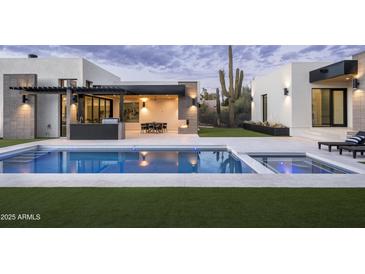 Luxury pool with patio, outdoor kitchen, and seating area at 9332 E La Posada Ct, Scottsdale, AZ 85255