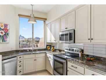 Modern kitchen features granite countertops, stainless steel appliances, and a lovely view at 10222 E Southwind Ln # 1066, Scottsdale, AZ 85262