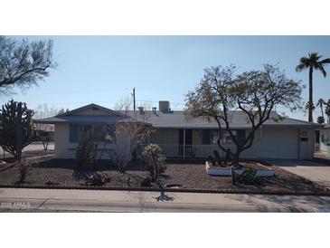 Ranch style home with carport and mature landscaping at 11001 W Connecticut Ave, Sun City, AZ 85351