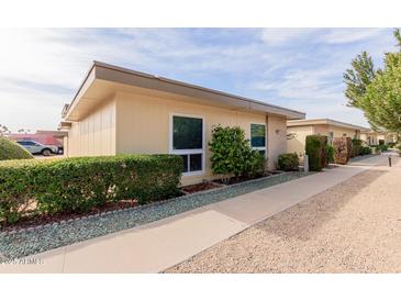 Light-beige condo building with walkway and landscaping at 14017 N 111Th Ave, Sun City, AZ 85351