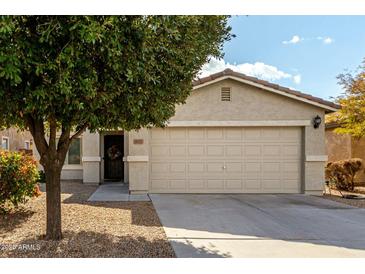 One-story house with tan exterior, two-car garage, and landscaping at 1615 E Maddison Cir, San Tan Valley, AZ 85140