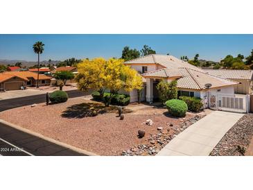 Two-story house with tile roof, desert landscaping, and gated entry at 17149 E El Pueblo Blvd, Fountain Hills, AZ 85268