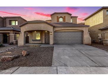 Two-story house with gray siding, a two-car garage, and landscaping at 1820 N 94Th Gln, Phoenix, AZ 85037