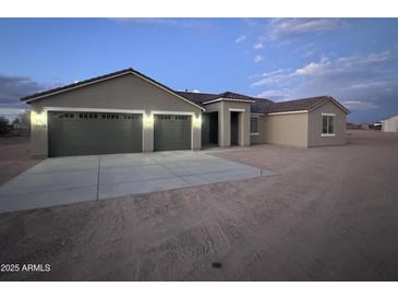 New construction home with three-car garage and desert landscaping at 19430 E Erik Ct, Florence, AZ 85132