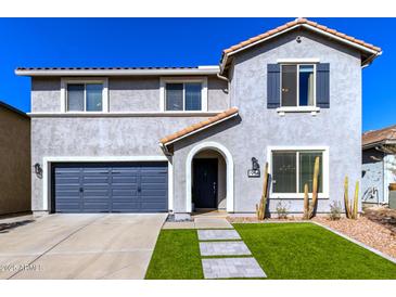 Two-story house with gray siding, a two-car garage, and a landscaped front yard at 1956 W Black Hill Rd, Phoenix, AZ 85085