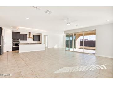 Open concept kitchen with island and access to living room at 19587 W Marshall Ave, Litchfield Park, AZ 85340