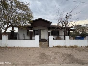 House exterior with front yard and white fence at 215 S 32Nd Dr, Phoenix, AZ 85009