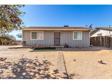 Ranch style home with a gray exterior and a small front yard at 21701 W Griffin Ave, Wittmann, AZ 85361