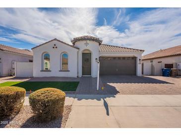 Charming single-story home with well-manicured landscaping and a two-car garage at 22235 E Cherrywood Dr, Queen Creek, AZ 85142