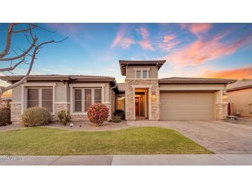 Single-story home with stone accents and landscaped front yard at 22812 E Excelsior Ave, Queen Creek, AZ 85142