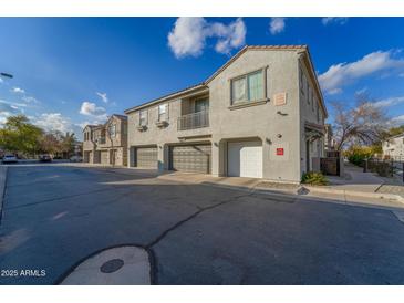 Tan stucco 2-story townhome with attached garage and balcony at 2960 E Darrow St, Phoenix, AZ 85042