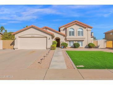 Charming two-story home with a well-manicured lawn and a spacious two-car garage at 3352 E Hopi Ave, Mesa, AZ 85204