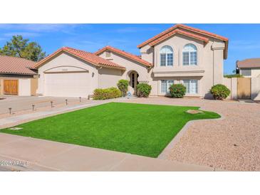 Charming two-story home with a well-manicured lawn and desert landscaping at 3352 E Hopi Ave, Mesa, AZ 85204