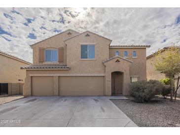 Two-story house with a three-car garage and desert landscaping at 5427 W St Kateri Dr, Laveen, AZ 85339