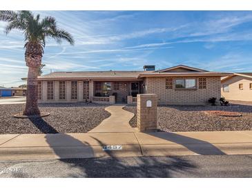 Brick ranch house with a landscaped front yard and walkway at 6457 E Dallas St, Mesa, AZ 85205