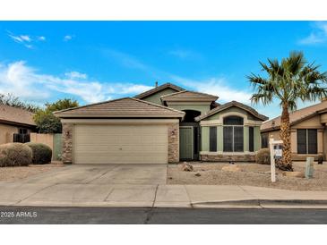 Charming single-story home with a two-car garage and desert landscaping at 8533 E Monte Ave, Mesa, AZ 85209