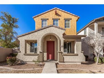 Two-story house with red door and neutral exterior at 106 N 66Th Ave, Phoenix, AZ 85043