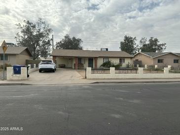 Ranch style home with carport and small front yard at 1321 W Pueblo Ave, Mesa, AZ 85202