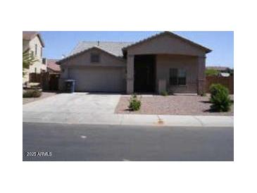 One-story house with attached garage and small front yard at 14970 W Riviera Dr, Surprise, AZ 85379