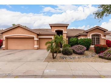 Charming single-story home featuring a well-manicured yard and a spacious three-car garage at 18001 N 53Rd St, Scottsdale, AZ 85254