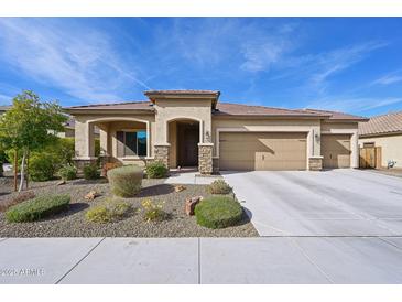 Single-story home with three-car garage and desert landscaping at 19684 N 260Th Ave, Buckeye, AZ 85396