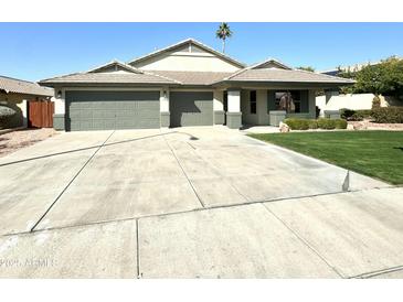 Single-story house with two-car garage, well-maintained lawn and landscaping at 22852 N 103Rd Ave, Peoria, AZ 85383