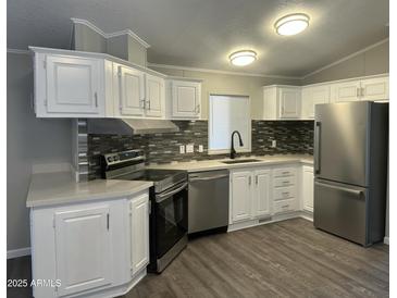 Modern kitchen features stainless steel appliances and white cabinets at 2787 W Cactus Wren St, Apache Junction, AZ 85120