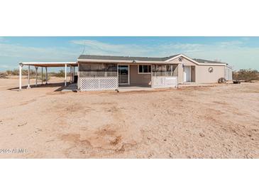 Ranch style home with covered patio and spacious backyard at 3315 N Datura Ct, Maricopa, AZ 85139