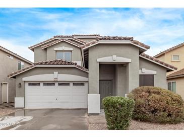Two-story house with a two-car garage and landscaping at 44230 W Palmen Dr, Maricopa, AZ 85138