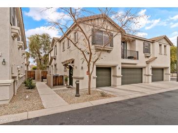 Two story townhome with attached two car garage, walkway and small front yard at 7446 S 30Th Run, Phoenix, AZ 85042