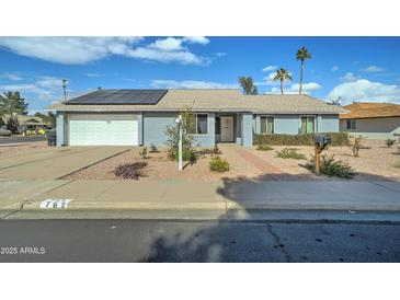 Ranch style home with solar panels and landscaped yard at 762 W Naranja Cir, Mesa, AZ 85210