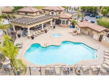 Community pool and spa with lounge chairs and covered seating at 10136 E Southern Ave # 1110, Mesa, AZ 85209