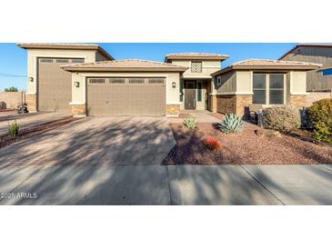 Charming single-Gathering home with a three-car garage and a well-maintained, xeriscaped front yard at 13855 S 181St Ave, Goodyear, AZ 85338