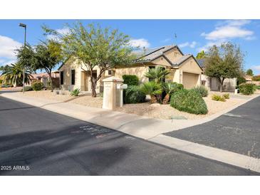 Charming home exterior featuring desert landscaping, a tile roof, and a well-maintained yard at 15738 W Clear Canyon Dr, Surprise, AZ 85374