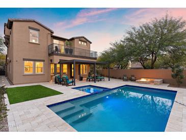 Luxury home with a sparkling pool, patio, and fire pit at 18140 N 92Nd St, Scottsdale, AZ 85255