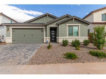 New construction home with a two-car garage and landscaped front yard at 21743 N Daniel Dr, Maricopa, AZ 85138