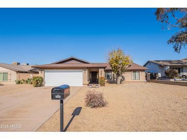 Single-story home with a two-car garage and desert landscaping at 2454 W Hearn Rd, Phoenix, AZ 85023