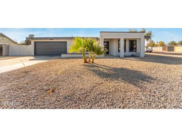 Newly renovated home with modern facade, two-car garage, and desert landscaping at 3301 E Larkspur Dr, Phoenix, AZ 85032