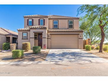 Two-story house with a beige exterior, two-car garage, and well-manicured landscaping at 36811 N El Morro Trl, San Tan Valley, AZ 85140