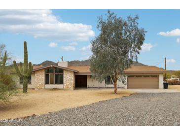 Charming home with desert landscaping, stone accents, and attached garage in a quiet neighborhood at 43006 N 3Rd Ave, New River, AZ 85087