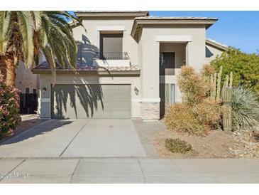 Two-story house with a two-car garage and desert landscaping at 4376 E Anderson Dr, Phoenix, AZ 85032