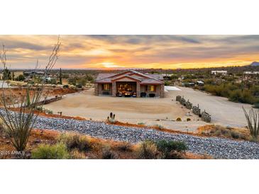 Aerial view of a single-story house with desert landscaping and a large yard at 5063 E Reavis St, Apache Junction, AZ 85119