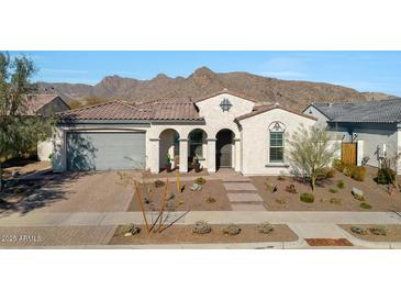 Single-story home with a tile roof, arched entryway, and landscaped front yard at 5252 N 206Th Dr, Buckeye, AZ 85396