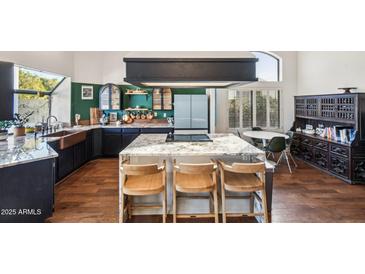 Modern kitchen with granite countertops and a farmhouse sink at 5582 W Aster Dr, Glendale, AZ 85304