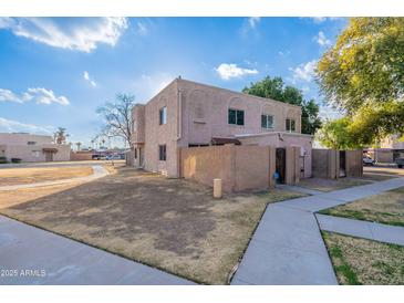 Two-story stucco building with a gated entry and landscaped yard at 600 S Dobson Rd # 166, Mesa, AZ 85202