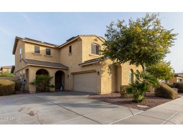 Two-story house with a three-car garage and landscaping at 850 E Del Rio St, Chandler, AZ 85225